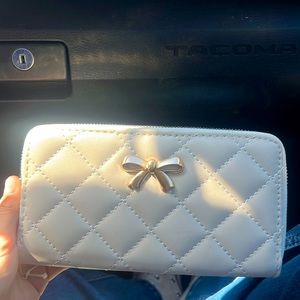 Hand purse light pink with gold bow and black inside